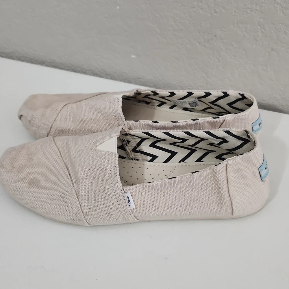 TOMS Shoes Size 9.5 Cream Canvas Slip-On has spots flaws